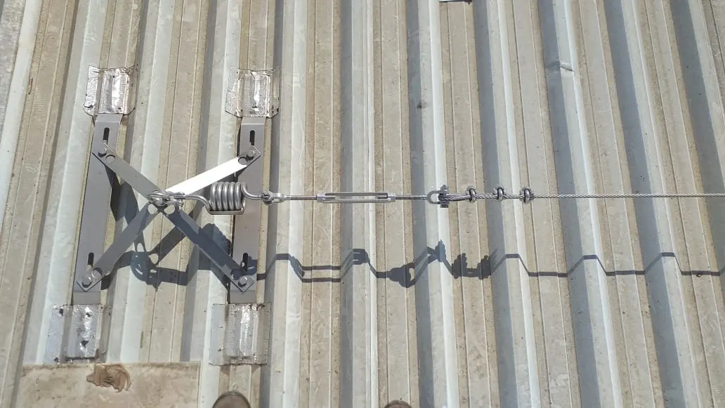 Spider-type stainless steel lifeline installed over a trapezoidal metal roof